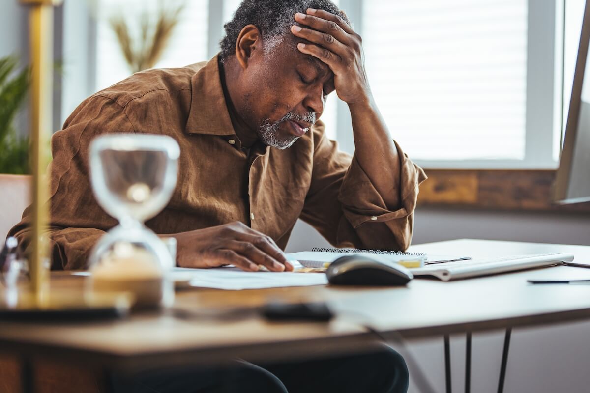 Concerned Senior Man Thinking at Desk_What Causes Memory Loss