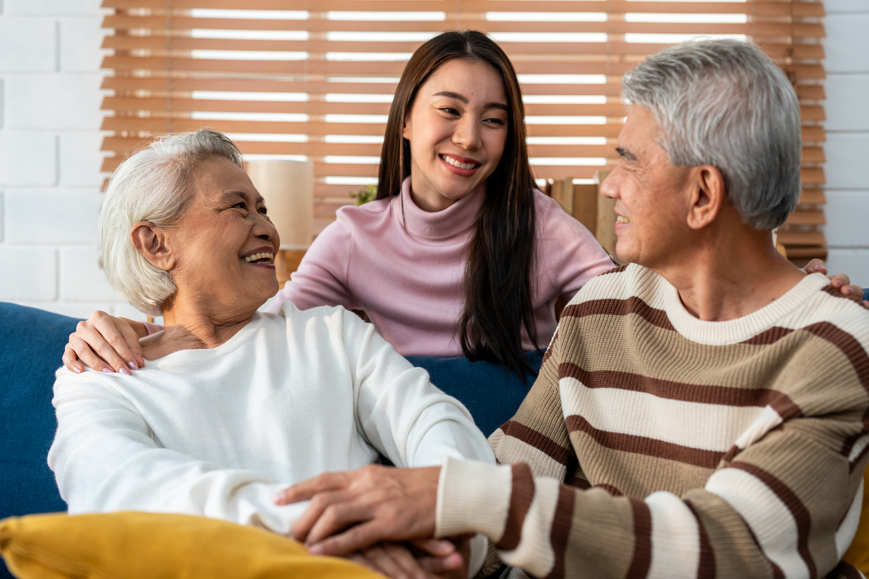 A young granddaughter visits her grandparents in a senior living community, keeping the family involvement in senior care going.