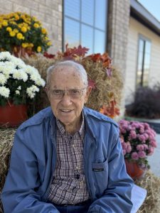 A senior resident smiles for the camera